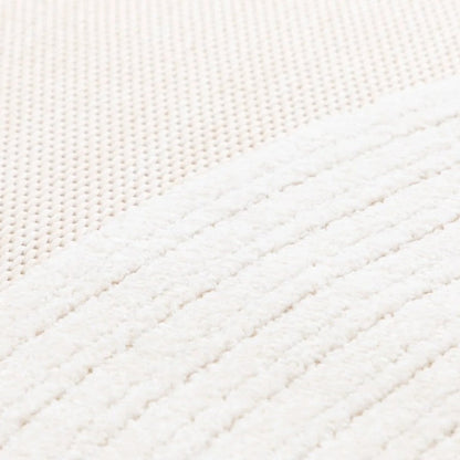 Close-up of a textured white fabric with diagonal stitching pattern