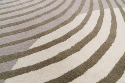 Close-up of a rug with wavy pattern in gray and white
