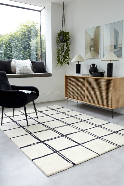 Asiatic Albany geometric rug UK in white with black grid pattern in modern living room setting