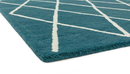 Asiatic luxury Albany geometric rug UK in teal with white angled line pattern, close-up on corner edge