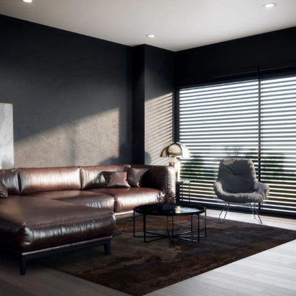 Modern living room with a brown leather sofa, coffee table, and chair.