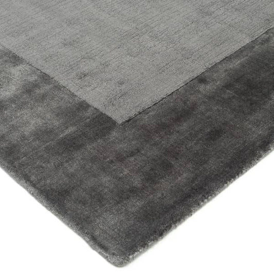 Grey rug with a textured pattern on a white background