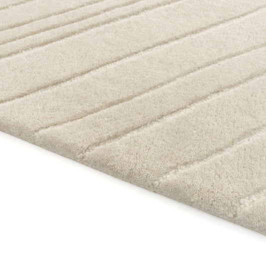 Close up of a beige wool rug on a white background 