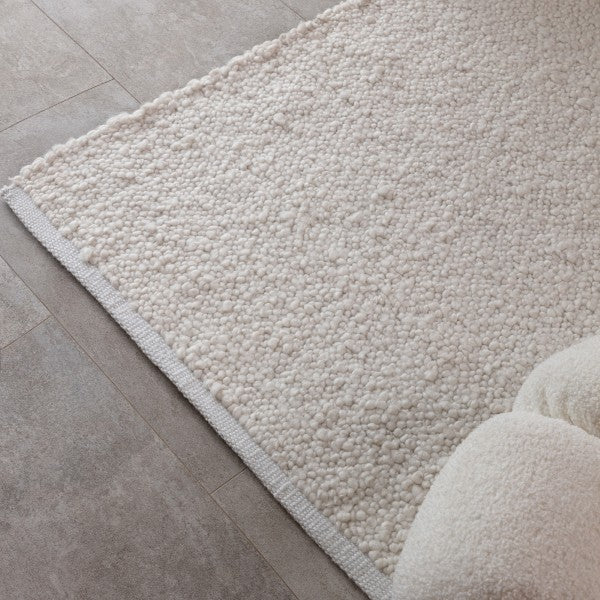 Asiatic luxury Boho Abbus Rug in cream with textured looped design on tiled floor