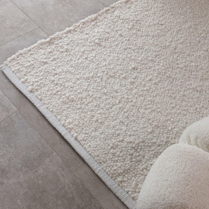 Asiatic luxury Boho Abbus Rug in cream with textured looped design on tiled floor