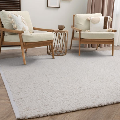 Asiatic Boho Abbus Rug luxury soft textured rug in neutral living room setting with wooden chairs