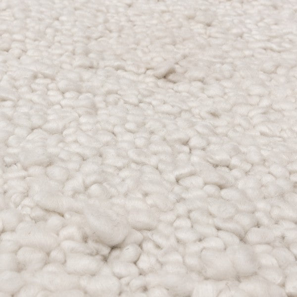 Close-up of Asiatic Boho Abbus Rug showcasing its soft, textured cream wool fibres in luxury design