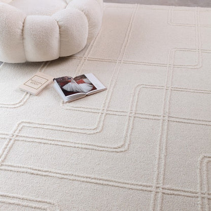 Luxury Boho Collection Ada Rug by Asiatic in cream with textured geometric pattern under cosy upholstered chair