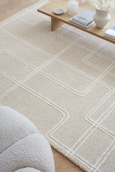 Asiatic Boho Collection Ada Rug luxury beige rug with geometric patterns under wooden coffee table