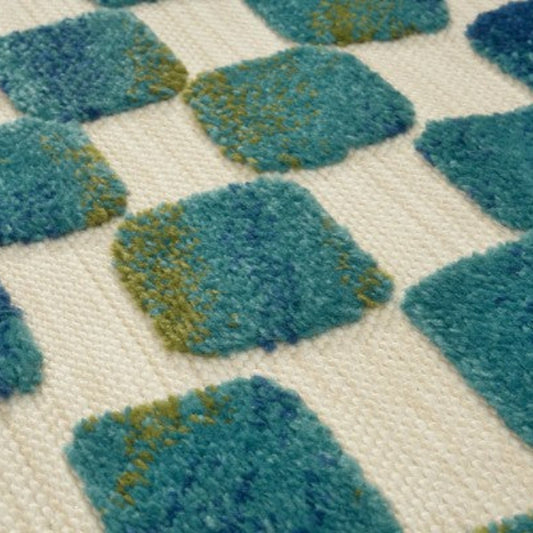 Calma Durable Out Door Rugs with a vibrant square pattern in teal and green for outdoor spaces