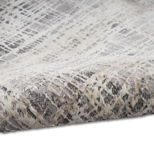 Close-up of the Calvin Klein Infinity Rug Collection showcasing a textured grey and cream design