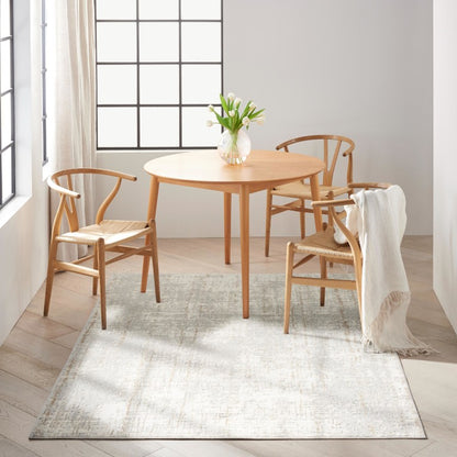 Elegant luxury rug from The Calvin Klein Rush Rug Collection in a light colour under a wooden table with chairs