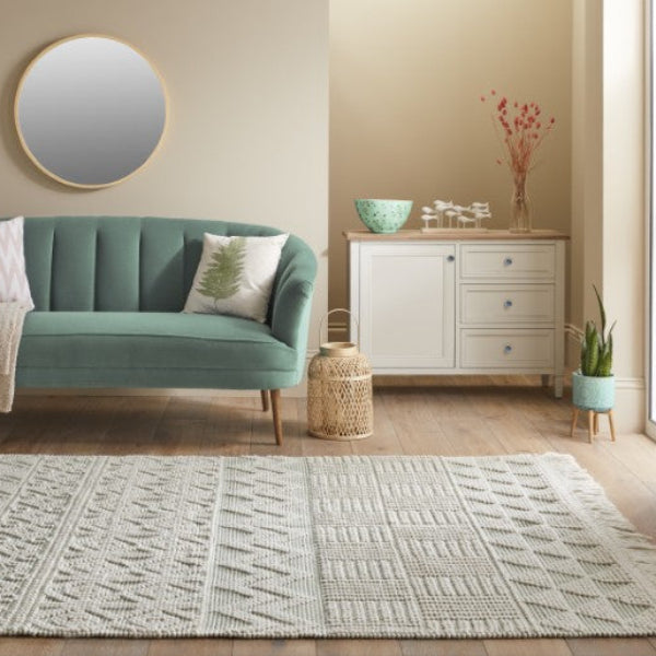Concept Looms Anya Rug luxury textured wool rug in a modern living room with green sofa and wooden flooring