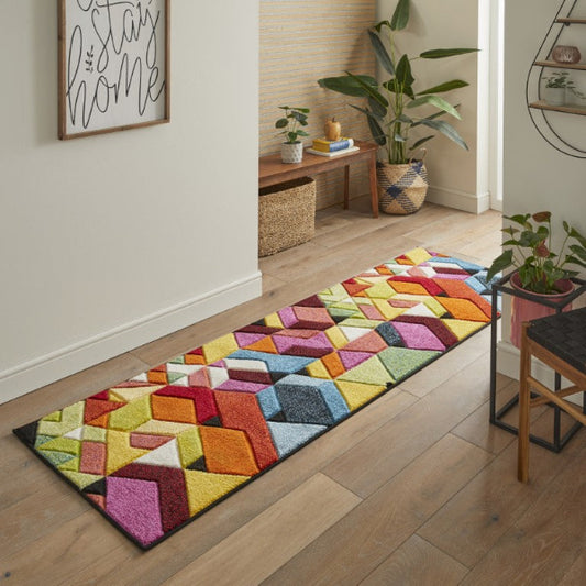 Colourful geometric patterned Concept Looms Viva Rug runner in modern hallway with wooden floor and plants