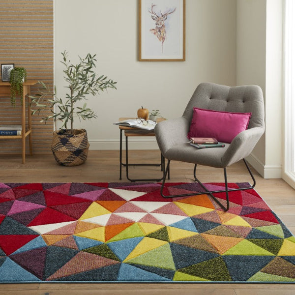 Concept Looms Viva Rug luxury colourful geometric patterned rug in modern living room with grey armchair