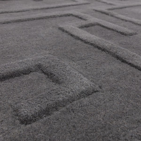 Close-up view of Asiatic Contemporary Plains Collection Maze Rug in dark grey with textured maze pattern