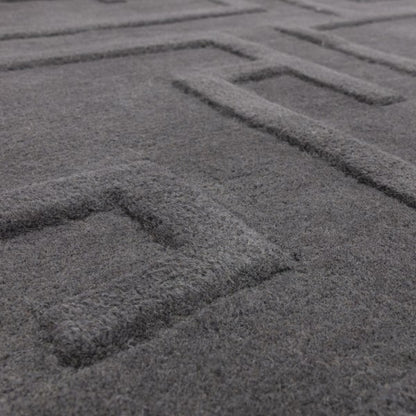 Close-up view of Asiatic Contemporary Plains Collection Maze Rug in dark grey with textured maze pattern