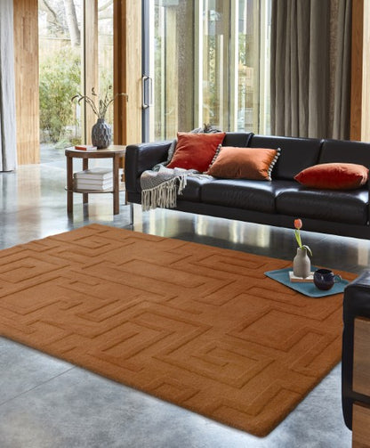 Luxury Contemporary Plains Collection Maze Rug in warm brown shade placed in modern living room