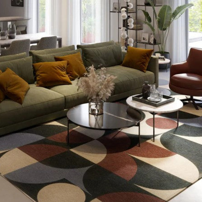 Modern living room with a sectional sofa, coffee table, and decorative rug.