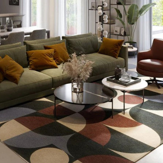 Modern living room with a sectional sofa, coffee table, and decorative rug.