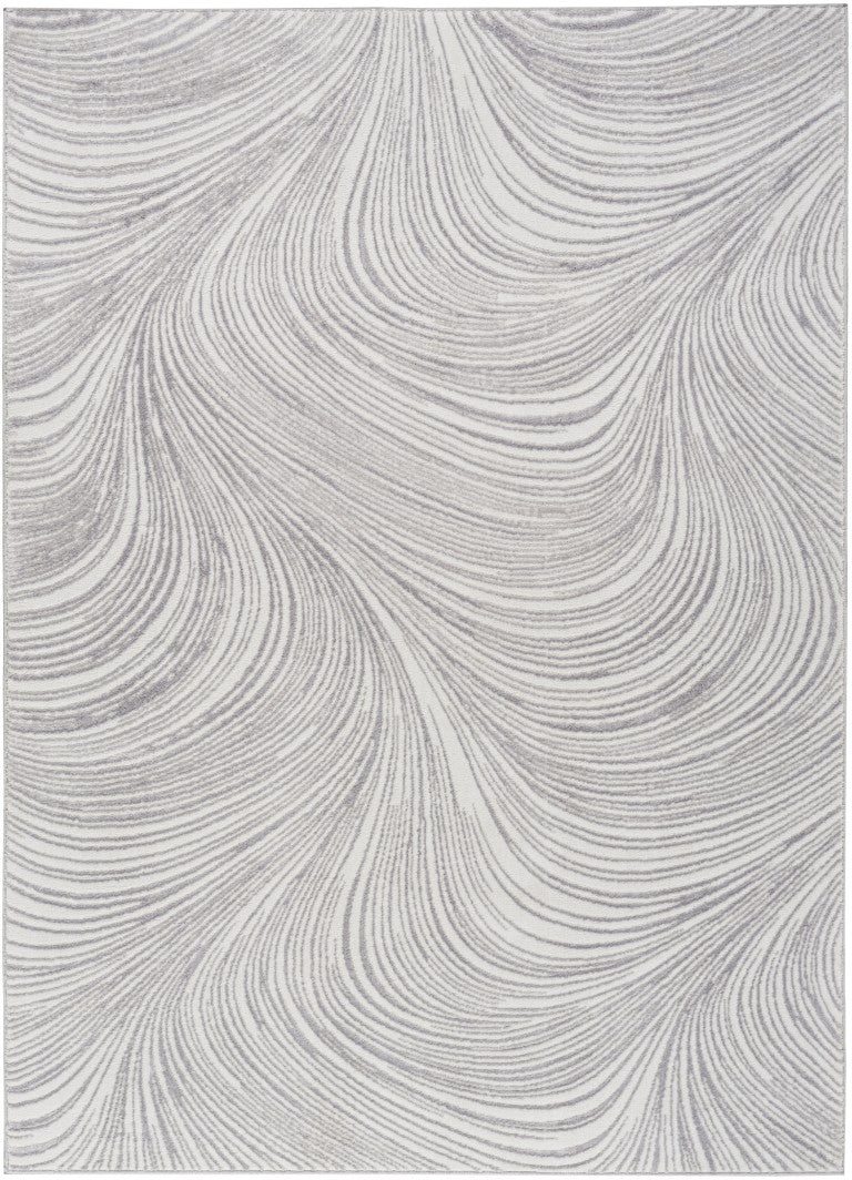 The DKNY Central Park West Rug Collection featuring elegant swirling patterns in soft grey tones