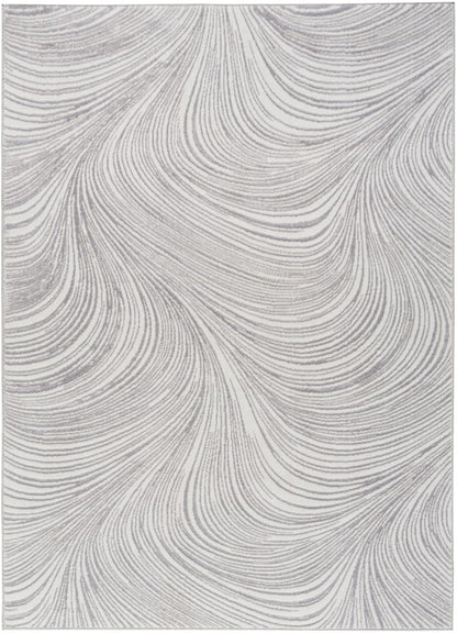 The DKNY Central Park West Rug Collection featuring elegant swirling patterns in soft grey tones