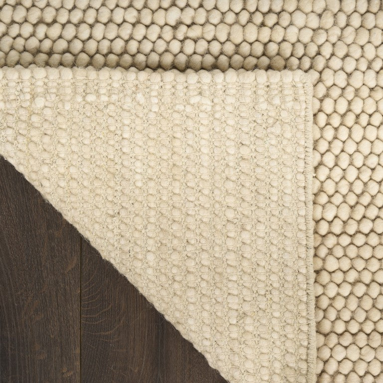 The DKNY Pure Knots Rug Collection featuring a textured cream rug with plush knots for a luxurious feel