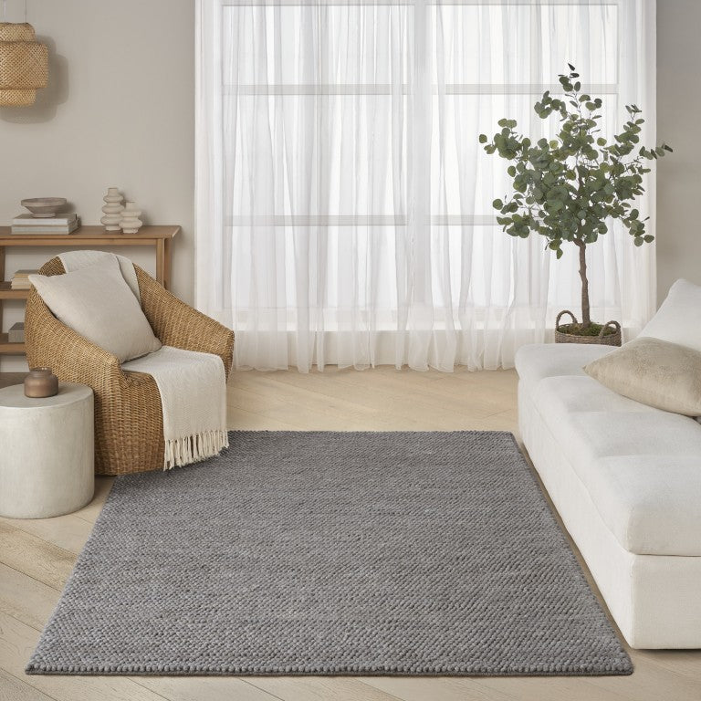 The DKNY Pure Knots Rug Collection in a modern living room setting with neutral decor