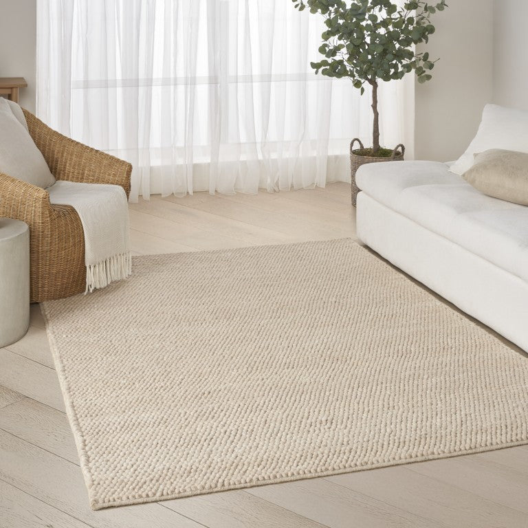 The DKNY Pure Knots Rug Collection in a neutral tone, enhancing a stylish living space with natural textures