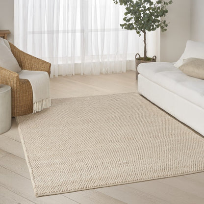 The DKNY Pure Knots Rug Collection in a neutral tone, enhancing a stylish living space with natural textures