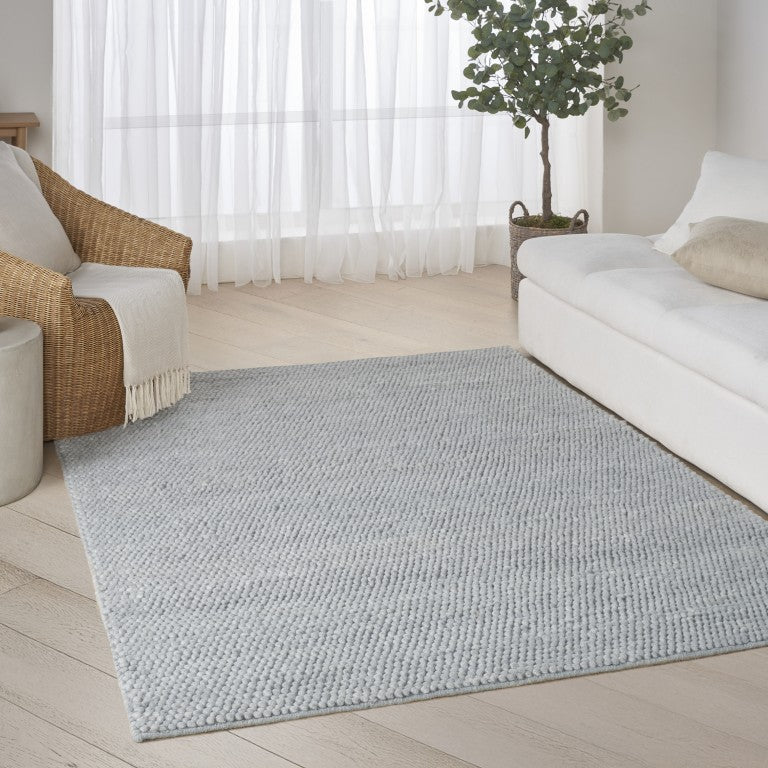 The DKNY Pure Knots Rug Collection in light grey, perfect for modern living areas and enhancing comfort