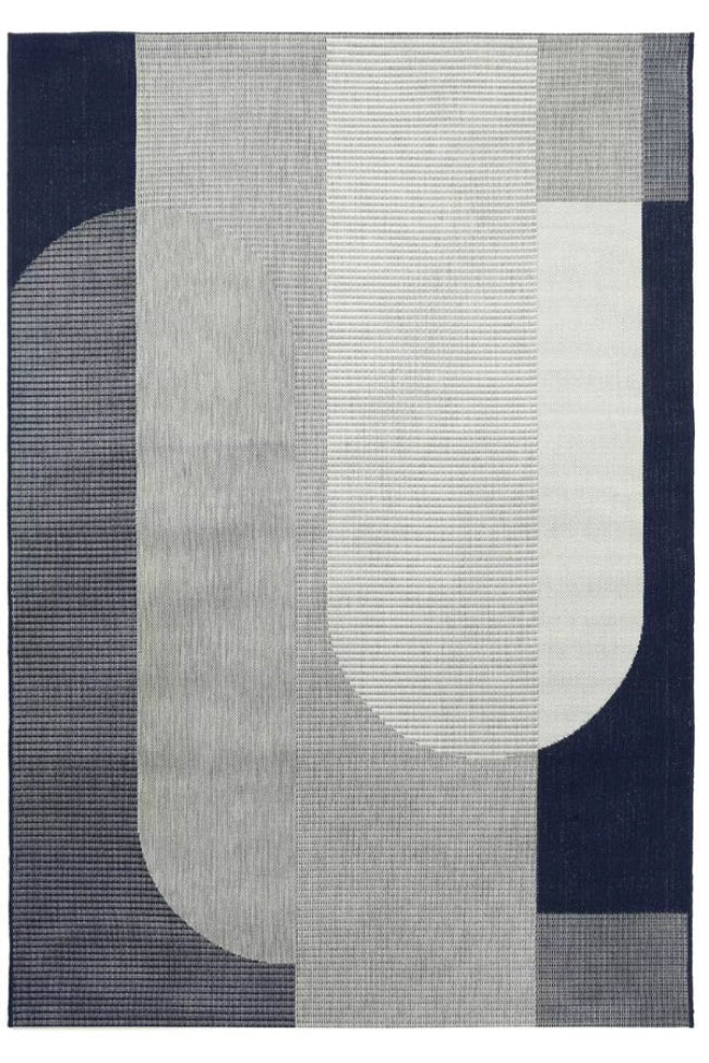 Geometric patterned rug with abstract shapes on a dark blue background