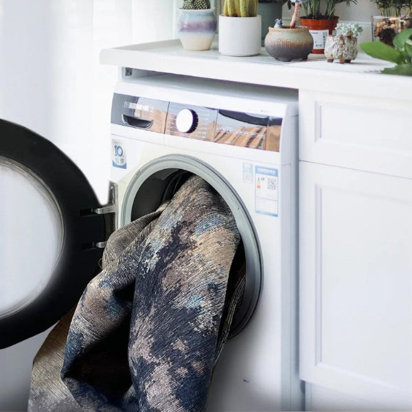 Laundry room with washing machine, dryer, and decorative plants.