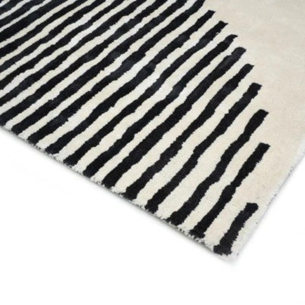 Black and white striped rug on a white background