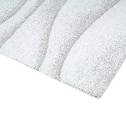 Close-up of a textured white sheet on a white background