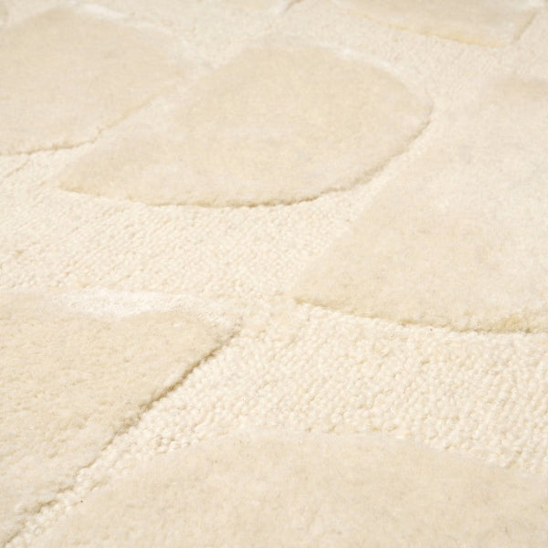 Close-up of a textured beige rug surface