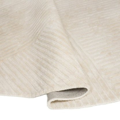 Close-up of textured beige fabric with a subtle pattern