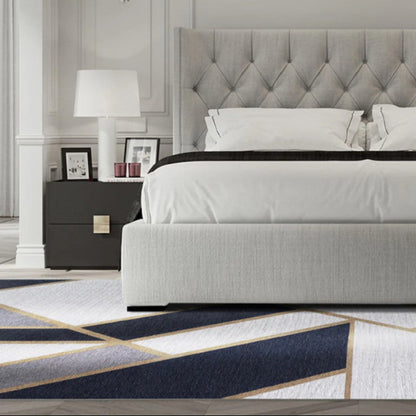 Modern bedroom with a gray upholstered bed and decorative elements.