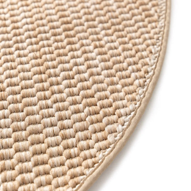 Close-up of a textured beige mat on a white background