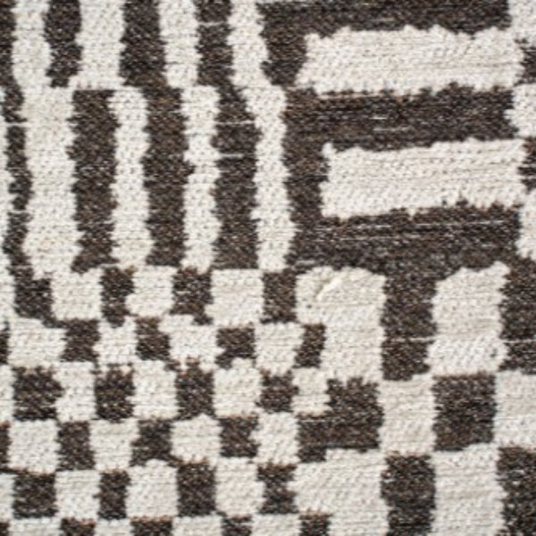 Close-up of Louis De Poortere Berber Rug showing intricate black and white geometric patterns