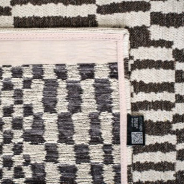 Close-up of Louis De Poortere Berber Rug showing detailed black and white geometric pattern and soft texture