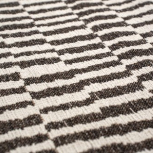 Close-up of Louis De Poortere Berber Rug with black and white striped geometric pattern