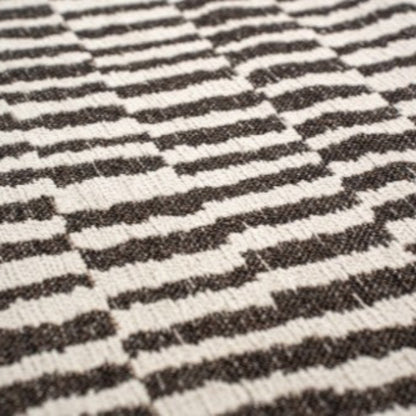 Close-up of Louis De Poortere Berber Rug with black and white striped geometric pattern