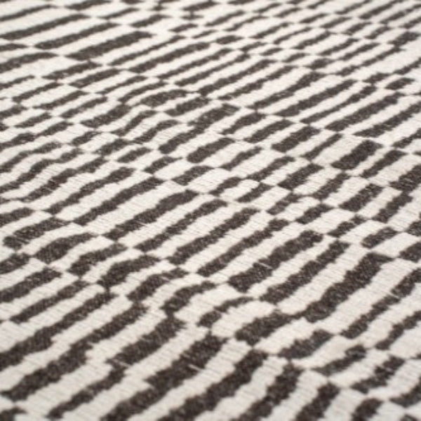 Close-up of a Louis De Poortere Berber Rug luxury rug with black and white geometric pattern