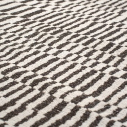 Close-up of a Louis De Poortere Berber Rug luxury rug with black and white geometric pattern