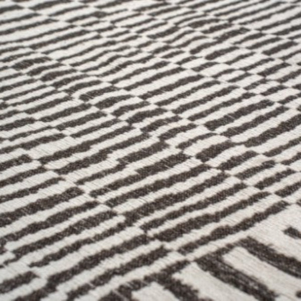 Close-up of luxury Louis De Poortere Berber Rug with black and white geometric pattern