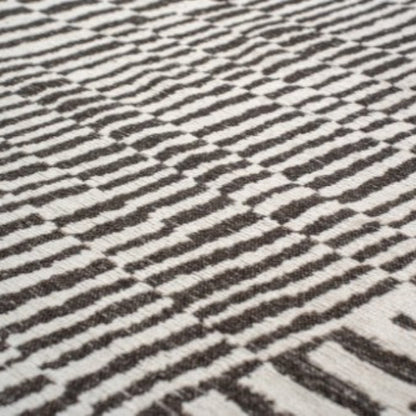 Close-up of luxury Louis De Poortere Berber Rug with black and white geometric pattern
