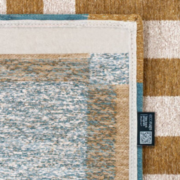Close-up of Louis De Poortere Chess rug showcasing detailed stitching and textured fabric in blue and brown tones