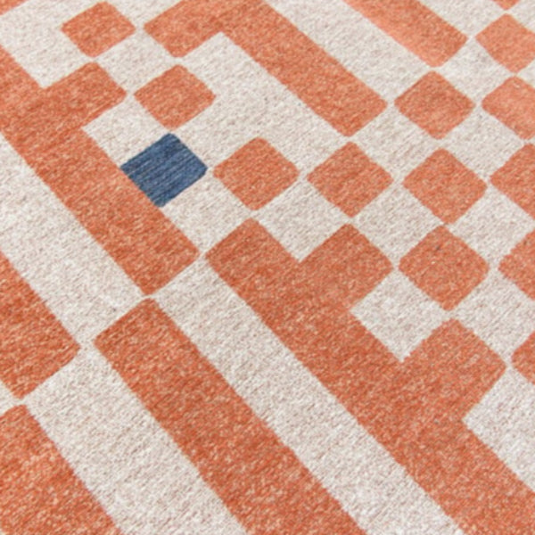 Close-up of luxury Louis De Poortere Chess rug with geometric pattern in orange, beige, and blue