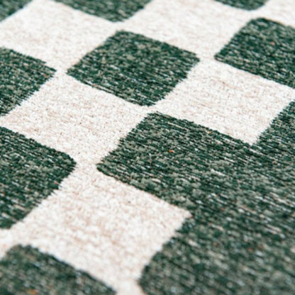 Close-up of Louis De Poortere Chess rug showing green and cream textured squares in luxury design